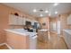 Kitchen features light wood cabinets, stainless steel appliances, and an island at 7895 Saint Giles Pl, Orlando, FL 32835