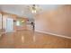 Spacious living room with hardwood floors and kitchen view at 7895 Saint Giles Pl, Orlando, FL 32835