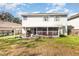 Spacious backyard featuring a back view of house with porch and screened in patio at 7909 Chartreux Ln, Maitland, FL 32751