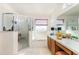 Bright and roomy bathroom area with a combined tub and shower behind glass doors at 7909 Chartreux Ln, Maitland, FL 32751