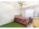 Cozy bedroom with a ceiling fan, window, and a small window air conditioning unit at 7909 Chartreux Ln, Maitland, FL 32751