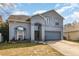 Attractive two-story home with a two car garage, blue-grey exterior and arched entryway at 7909 Chartreux Ln, Maitland, FL 32751