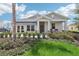 One-story home with gray siding, front porch, and landscaped yard at 867 Pebble Crest Ln, Eagle Lake, FL 33839