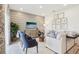 Living room with sectional sofa, wood accent wall, and large windows at 867 Pebble Crest Ln, Eagle Lake, FL 33839