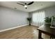 Bright bedroom with wood-look floors, ceiling fan, and window coverings at 884 Great Bend Rd, Altamonte Springs, FL 32714