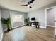 Bright bedroom with wood-look floors, window, ceiling fan and workspace at 884 Great Bend Rd, Altamonte Springs, FL 32714