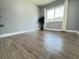 Well-lit bedroom featuring wood-look floors and a large window at 884 Great Bend Rd, Altamonte Springs, FL 32714