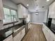 Modern kitchen with white shaker cabinets, granite counters, and stainless steel sink at 884 Great Bend Rd, Altamonte Springs, FL 32714