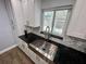 Modern kitchen with white cabinets, granite countertops and farmhouse sink at 884 Great Bend Rd, Altamonte Springs, FL 32714