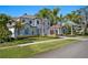 Two-story home with light-grey facade, palm trees and a long driveway at 9122 Bay Point Dr, Orlando, FL 32819