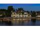 Luxury waterfront home with expansive lake views at dusk at 9122 Bay Point Dr, Orlando, FL 32819