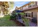 Landscaped backyard with a screened patio and lush greenery at 10329 Belfry Cir, Orlando, FL 32832