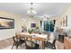 Bright dining area with wood table, chairs, and access to the living room at 10329 Belfry Cir, Orlando, FL 32832