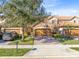 Townhouse with a stone facade and two-car garage at 10329 Belfry Cir, Orlando, FL 32832