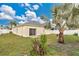 Backyard view of home with palm trees and fence at 1122 Hacienda Cir, Kissimmee, FL 34741