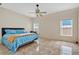 Main bedroom with a ceiling fan and large windows at 1122 Hacienda Cir, Kissimmee, FL 34741