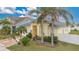 Exterior of house with palm trees and driveway at 1122 Hacienda Cir, Kissimmee, FL 34741