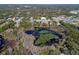 Aerial view of lake surrounded by lush greenery and neighboring buildings at 1254 Seminola Blvd, Casselberry, FL 32707