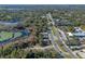 Wide aerial view showing home's location near lake and businesses at 1254 Seminola Blvd, Casselberry, FL 32707