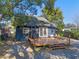 Backyard featuring a patio and a charming blue house under a sunny sky at 1254 Seminola Blvd, Casselberry, FL 32707