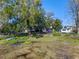 Scenic backyard view featuring lush greenery, mature trees, and waterfront access at 1254 Seminola Blvd, Casselberry, FL 32707