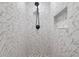 Clean shower with marble-style tile and pebble stone shower floor at 1254 Seminola Blvd, Casselberry, FL 32707