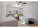Bright bedroom featuring two twin beds with decorative pillows and neutral-toned tiled flooring at 1254 Seminola Blvd, Casselberry, FL 32707