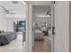 Inviting bedroom featuring neutral tones, tiled floors, and seamless indoor-outdoor flow to a lakeside view at 1254 Seminola Blvd, Casselberry, FL 32707