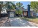 Charming one-story home with a concrete driveway and a dark blue exterior at 1254 Seminola Blvd, Casselberry, FL 32707