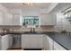 Updated kitchen featuring white cabinets, dark countertops, and a stylish sink at 1254 Seminola Blvd, Casselberry, FL 32707