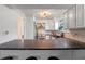 Modern kitchen featuring a stainless steel range hood and black countertop at 1254 Seminola Blvd, Casselberry, FL 32707