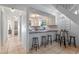 Open kitchen with breakfast bar, white cabinets, and stainless steel dishwasher at 1254 Seminola Blvd, Casselberry, FL 32707