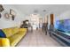Cozy living space featuring a sofa, kitchenette, desk, and a TV for entertainment at 1254 Seminola Blvd, Casselberry, FL 32707