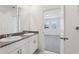 Bathroom with double sink vanity, granite counters, and bright natural lighting at 1373 Current Pl, Haines City, FL 33844