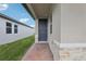 Exterior shot of the front entrance and side of home showcasing the brick paver walkway and neutral paint at 1373 Current Pl, Haines City, FL 33844