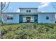 Home's backyard with covered patio and view into the home at 15913 Winding Bluff Dr, Montverde, FL 34756