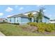 Charming single-story home featuring a light blue exterior, white trim, and lush landscaping at 15913 Winding Bluff Dr, Montverde, FL 34756
