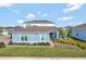 Charming single Gathering home with well maintained lawn, garden bed, and soft blue paint at 15913 Winding Bluff Dr, Montverde, FL 34756