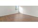 Empty bedroom with wood floors, baseboards, and window view at 16309 Sw Sw 27Th Cir, Ocala, FL 34473