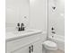 Bright bathroom features a white vanity with a solid surface top, black hardware, and a tub with a shower at 17031 Sw 20Th Court Rd, Ocala, FL 34473