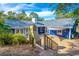 An exterior view of the backyard, which features an outdoor brick patio, a stone fireplace, and lush greenery at 1720 Overlook Rd, Longwood, FL 32750