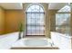 Tranquil bathroom with a soaking tub and a large window at 1720 Overlook Rd, Longwood, FL 32750