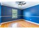 Empty bedroom with beautiful hardwood floors, a ceiling fan, and a large window at 1720 Overlook Rd, Longwood, FL 32750