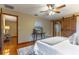 Bedroom with hardwood floors, barn door, and access to another room at 1720 Overlook Rd, Longwood, FL 32750