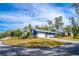 Blue home with white garage door and mature landscaping at 1720 Overlook Rd, Longwood, FL 32750