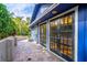 Side view of a blue building showing the black-framed glass doors and red brick pavers at 1720 Overlook Rd, Longwood, FL 32750