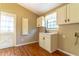 Bright laundry room with white cabinets and vinyl flooring at 1720 Overlook Rd, Longwood, FL 32750