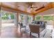 Living area with wood ceiling, hardwood floors and multiple doors leading to a patio at 1720 Overlook Rd, Longwood, FL 32750