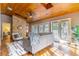 Cozy living room with wood ceiling, brick fireplace and hardwood floors at 1720 Overlook Rd, Longwood, FL 32750