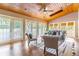 Relaxing living room with wood ceiling, hardwood floors and multiple access points to the outdoors at 1720 Overlook Rd, Longwood, FL 32750